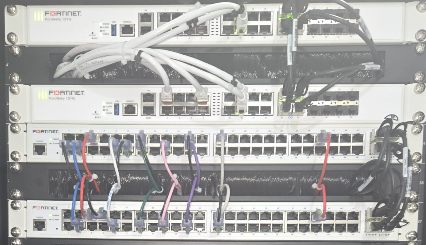 Installed FortiGate and FortiSwitch equipment with redundant copper and fiber connections in a network rack